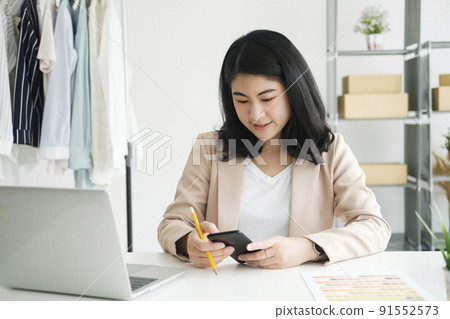 Designer using computer and drawing sketches for new collection Designer using computer and drawing sketches for new collection 91552573