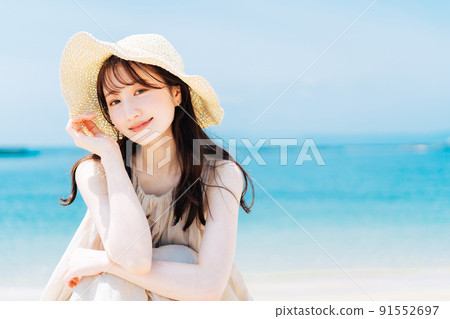 Woman against the backdrop of the sea and blue sky 91552697