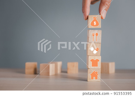 hand putting money bag wood cube arranging on four requisites cube stack hand putting money bag wood cube arranging on four requisites cube stack 91553395