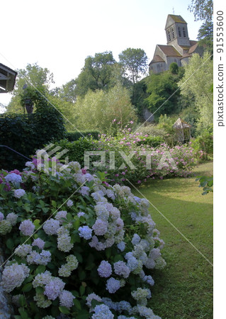 A church standing on a hill and a landscape of hydrangeas A church standing on a hill and a landscape of hydrangeas 91553600