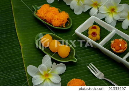 Thai traditional dessert concept, Assorted Thai dessert served in a plate on banana leaf background 91553697