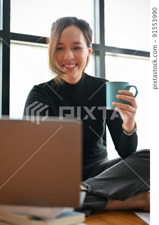 Beautiful young Asian female freelancer or female journalist working on laptop Beautiful young Asian female freelancer or female journalist working on laptop 91553990