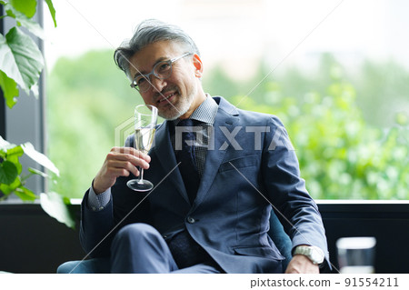 Senior owner with a glass of champagne Senior owner with a glass of champagne 91554211