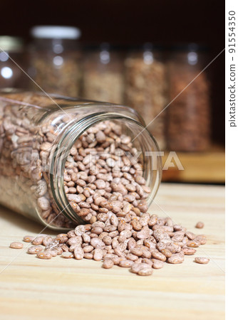 Jar of Pinto Beans Spilled on Kitchen Table 91554350