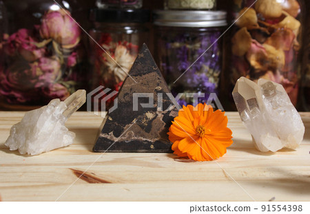 Quartz Crystals and Stone Pyramid With Flower. Relaxation and Meditation Decor 91554398