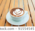 High angle Latte art coffee on wooden table in coffee shop. 91554545