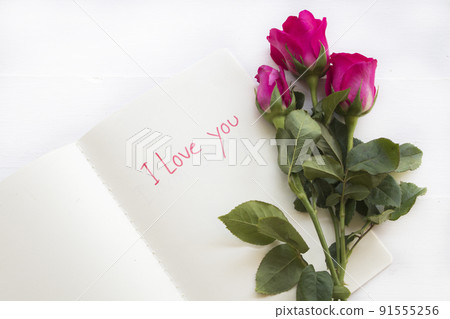 i love you message card handwriting on notebook with rose flowers  91555256