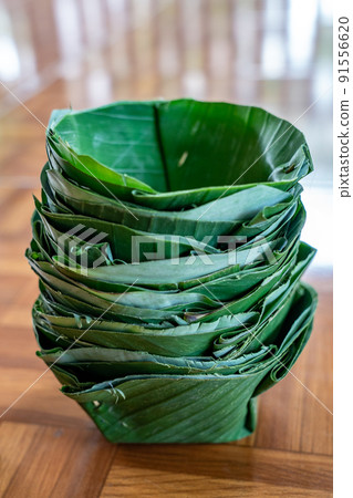 Local and traditional TRAY FOOD (eco prackaging) made to dish and bowl from banana leaf, arranged together like a tower. 91556620