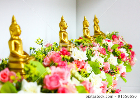 four gold buddha on the flower in the row. four gold buddha on the flower in the row. 91556650