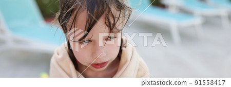 Wet frozen child by the pool, covered with a towel Wet frozen child by the pool, covered with a towel 91558417