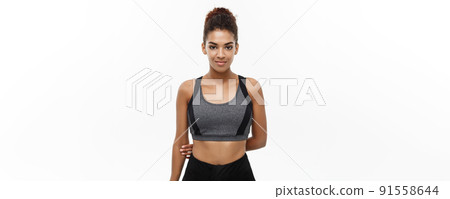 Healthy and Fitness concept - Beautiful American African lady in fitness clothes ready for workout. Isolated on white background. 91558644