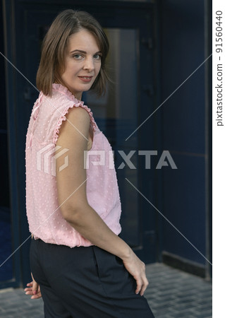 Middle-aged woman in pink blouse outside. Portrait of brunette girl with bob haircut Middle-aged woman in pink blouse outside. Portrait of brunette girl with bob haircut 91560440