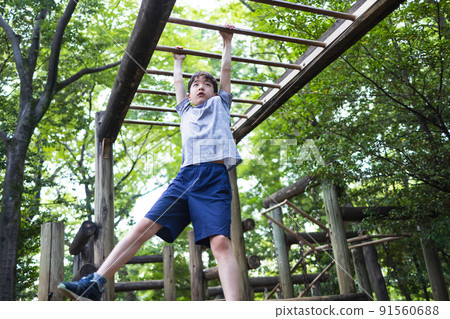 Boy playing well in the park Boy playing well in the park 91560688