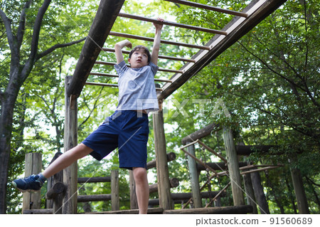 Boy playing well in the park Boy playing well in the park 91560689