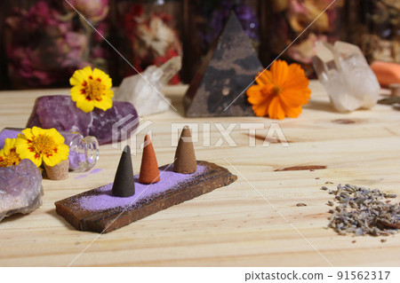 Incense Cones on Stone Slab With Crystals and Flowers 91562317