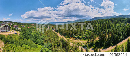 Aerial view of beautiful mountains, covered with forest and open cable car road, long panorama. Karpacz resort in Poland with lift road. Family outdoor recreation in mountains 91562924