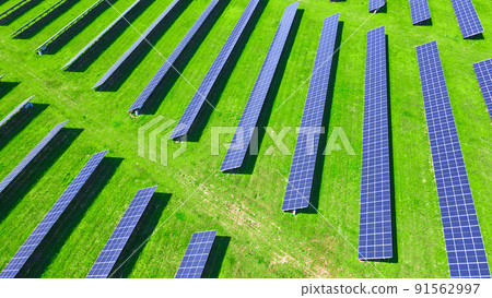Solar panels battery in green field, aerial view. Photovoltaic modules for renewable energy. Concept of clean, sustainable, alternative energy Solar panels battery in green field, aerial view. Photovoltaic modules for renewable energy. Concept of clean, sustainable, alternative energy 91562997