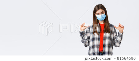 Coronavirus outbreak, leisure on quarantine, social distancing and emotions concept. Confident young woman in medical mask, freelancer pointing herself, show-off or bragging personal achievement 91564596