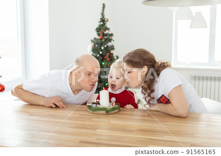 Child girl dressed in christmas dress with cochlear implants having fun at home - diversity and hearing aid and innovating technologies for treatment of deafness. Child girl dressed in christmas dress with cochlear implants having fun at home - diversity and hearing aid and innovating technologies for treatment of deafness. 91565165