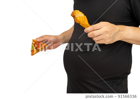 A man holding fried chicken and worrying about his stomach A man holding fried chicken and worrying about his stomach 91566336