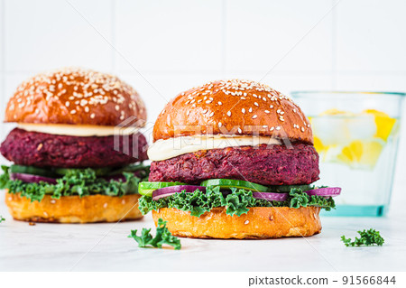 Beetroot vegan burger with kale, onion and cucumber. Alternative fast food. Purple food. Beetroot vegan burger with kale, onion and cucumber. Alternative fast food. Purple food. 91566844