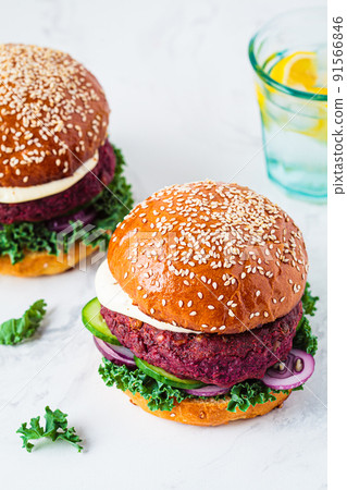 Beetroot vegan burger with kale, onion and cucumber. Alternative fast food.  Purple food. 91566846