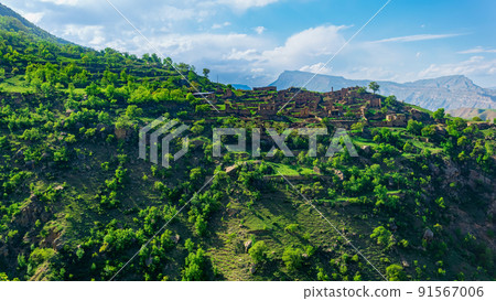 ruins of houses on a mountainside in Kurib, a depopulated village with the only remaining household with an apiary, Dagestan 91567006