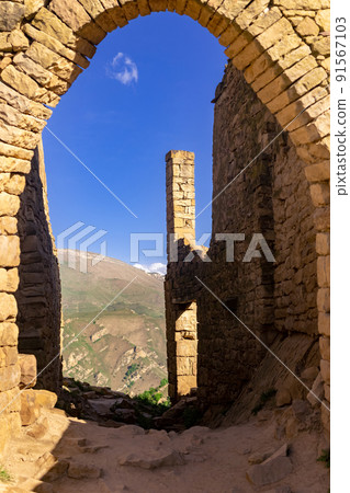 beautiful stone arch in the ruins of the abandoned ancient village of Gamsutl, Dagestan 91567103