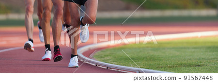 Athletics people running on the track field.Running a race on a track for sports competition and winning 91567448