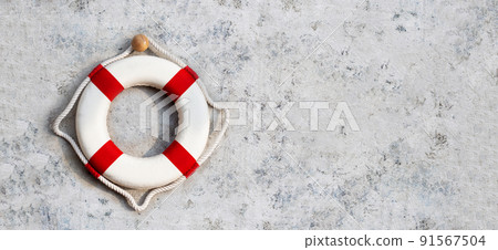 Lifebuoy on cement wall background. Copy space Lifebuoy on cement wall background. Copy space 91567504