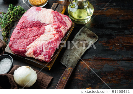 Point brisket, raw beef brisket meat,with ingredients for smoking  making  barbecue, pastrami, cure, on old dark  wooden table background,  with copy space for text 91568421