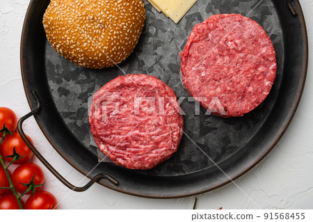 Burger patty on white stone table background, top view flat lay Burger patty on white stone table background, top view flat lay 91568455