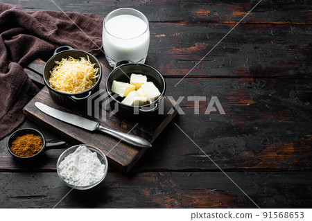 White Bechamel sauce ingredients, on old dark  wooden table background, with copy space for text 91568653