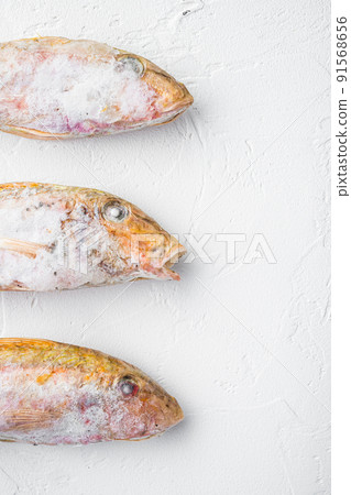 Frozen Goatfish raw fish, on white stone table background, top view flat lay , with copy space for text 91568656