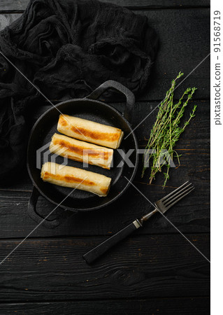 Georgian crepes stuffed on black wooden table background, top view flat lay, with copy space for text 91568719