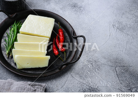 Greek fresh  Halloumi cheese set, on gray stone table background, with copy space for text 91569049