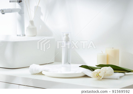 Cosmetics product and cotton towels, cottons pad with green plant on white table inside a bathroom background ceramic. 91569592