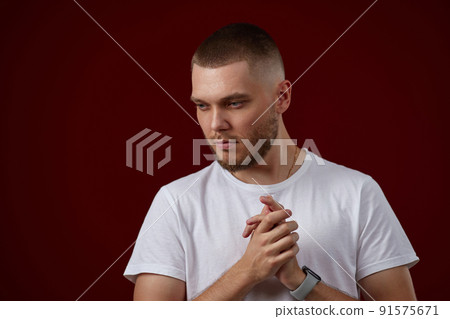 handsome man in a white t-shirt thinks about something handsome man in a white t-shirt thinks about something 91575671