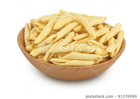 Typical Calabrian pasta called Maccheroncini or Maccheroni in wooden bowl isolated on white background with full depth of field. 91576099