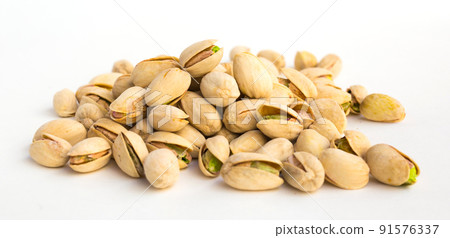 roasted pistachios on white background 91576337