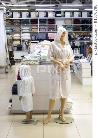 Mannequins of a woman and a child in white coats in a textile store Mannequins of a woman and a child in white coats in a textile store 91576796