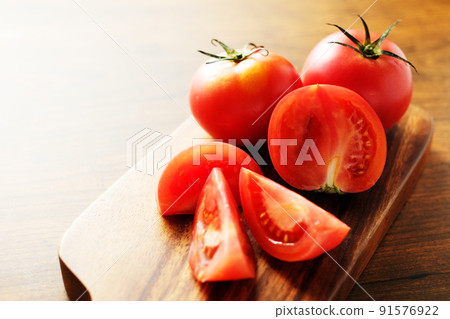 Tomato on the cutting board Tomato on the cutting board 91576922