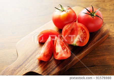 Tomato on the cutting board Tomato on the cutting board 91576980