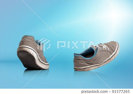 Urban sports shoes over blue background. Sneakers or trainers isolated. Athletic shoes. fitness, sport, training concept. Urban fashion 91577265