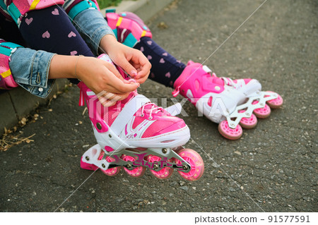 Close-up Of Legs Wearing Roller Skating Shoe, Outdoors Close-up Of Legs Wearing Roller Skating Shoe, Outdoors 91577591