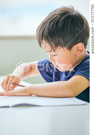 在筆記本上寫字的小學生 91577700