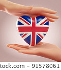 Two hands holding heart with flag of Untied Kingdom. Concept of love, freedom, independence and England country support. 3D rendering. 91578061