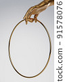 Golden female hand holding round golden frame. Background for cosmetics, fashion, product show. 3D rendering. 91578076