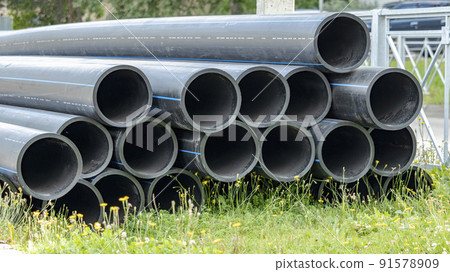 black sewer pipes on the construction site are stacked on top of each other 91578909