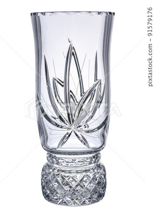 Crystal Empty glass Faceted Transparent Vase with carving pattern isolated on white background. Vintage item Use for flowers and interior decoration. Crystal Empty glass Faceted Transparent Vase with carving pattern isolated on white background. Vintage item Use for flowers and interior decoration. 91579176